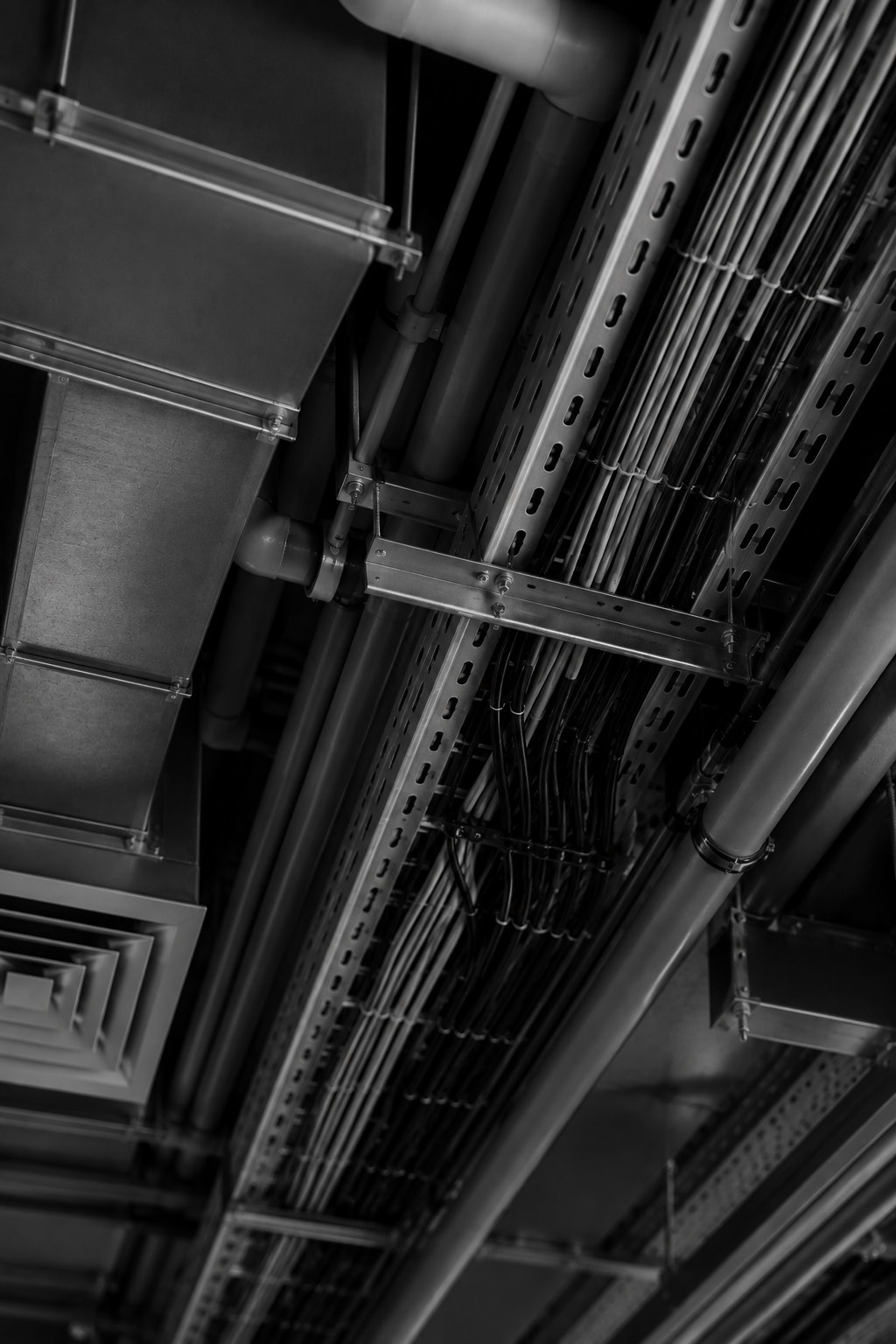 Mechanical ductwork and cable trays beneath a ceiling